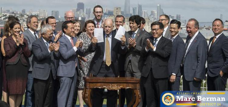 Gov. Jerry Brown signs bills into law, one of which was AB 19, giving students one year of free community college tuition.