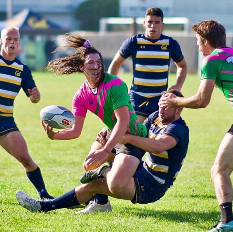 James Zanoli looks to complete a quick pass as he is brought to the ground. Photo by Joe Marcelo