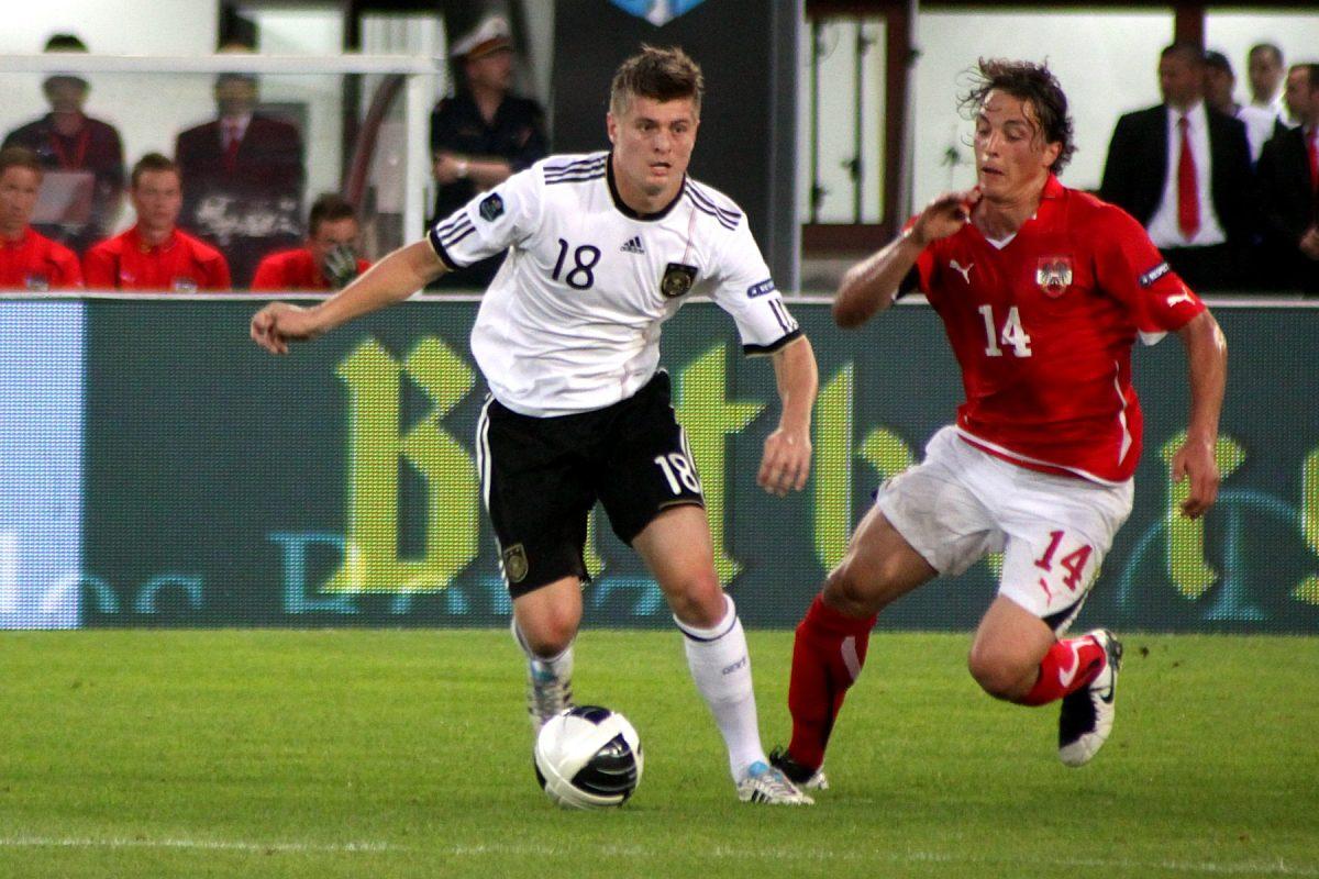 Toni Kroos of Germany dribbles past Austrian player Julian Baumgartlinger in the 2012 UEFA Euro competition. Photo by Steindy