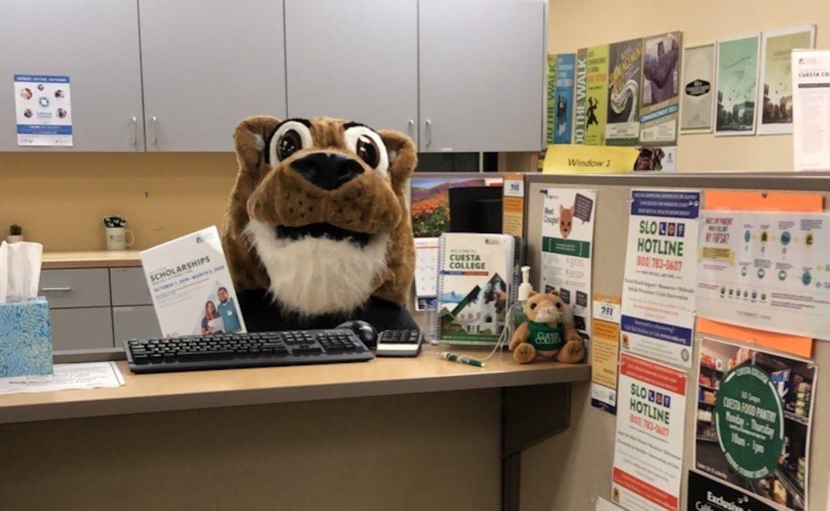 Cougie (Christina Sholars, financial aid specialist) waits to assist students in the financial aid office. Photo by Leah Monson