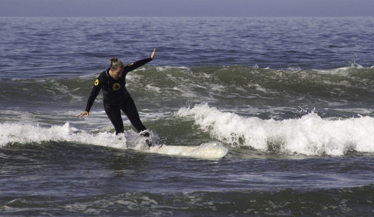 Jennifer Fanning, city of Atascadero recreation supervisor and cancer survivor, surfing her first wave at the Womenâ€™s Cancer Survivor Summit held at Pismo Beach. Photo by Adrian Martino
