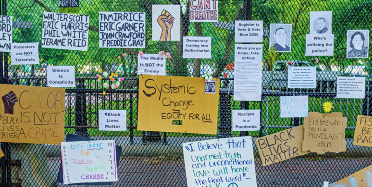 Black Lives Matter and anti-discrimination signs line a fence in Washington D.C. after protests following the murder of George Floyd. Photo by Ted Eytan