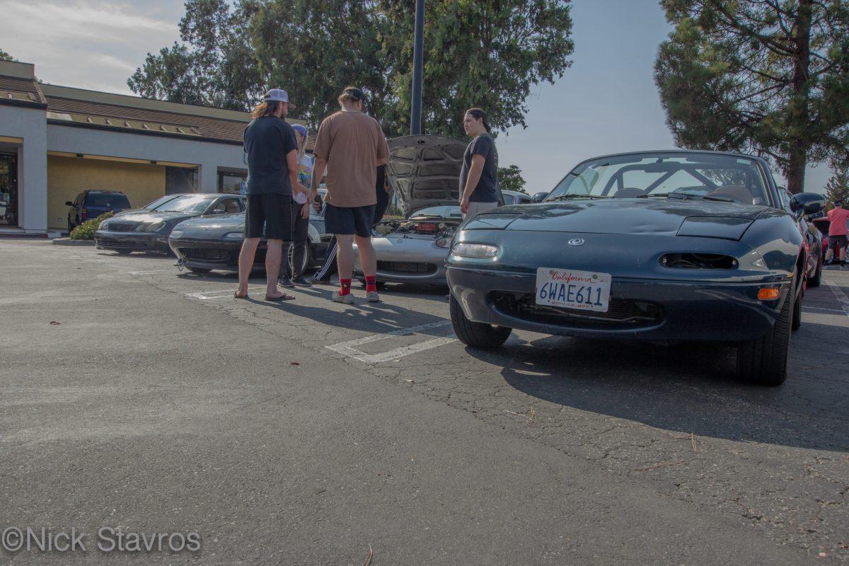 The lineup â€“ three Mazda Miatas and a Lexus. Most try to park near the associated vehicle brands or car crew and make relationships in the car community.  Photo by Nick Stavros