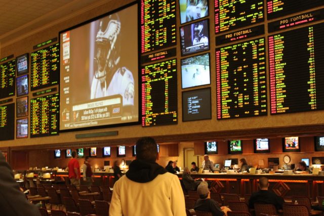 A casino video board shows the lines for that day's sporting events.
