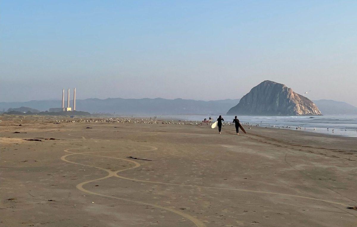 Two surfers near Morro Rock, This area will be excluded from the sanctuary to make room for offshore wind turbines. Photo by Kathleen Mireles