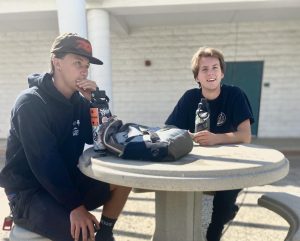 Two Cuesta College students chat while waiting for class outside the 7100 building on Aug. 12.