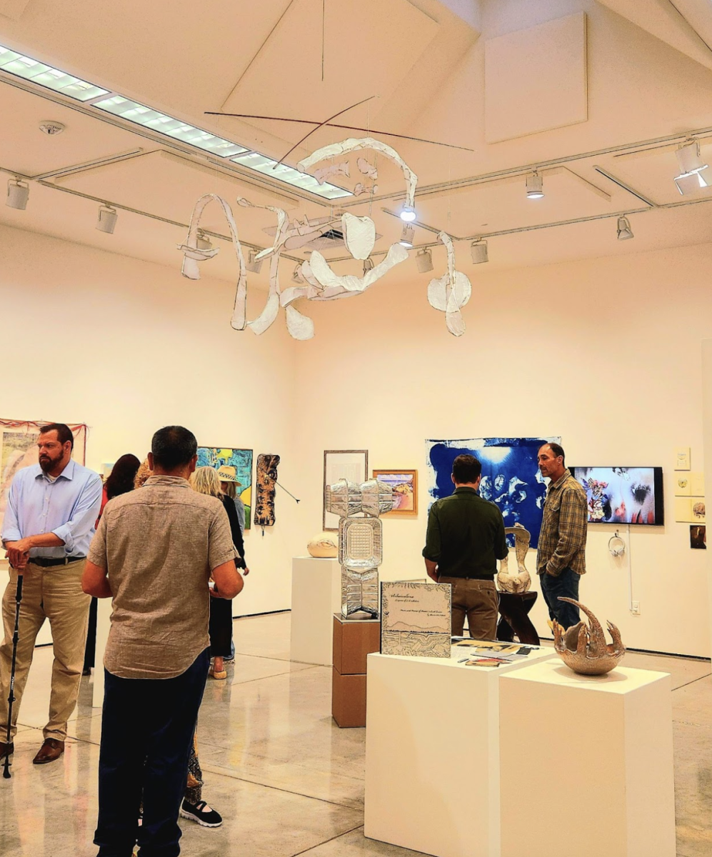 People gather to look at the different displays of art in the Harold J. Miossi Gallery on Aug. 14.
