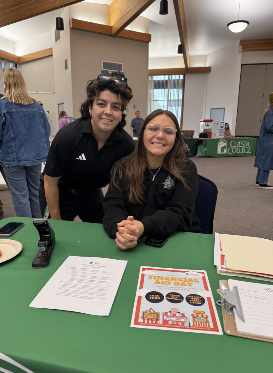 On Feb. 10, students were greeted by Student Life and Leadership Program Coordinator Gabby Flores (left) and Student Representative Surry McNutt (right) at the entrance to the Club Fair in Room 5401 at the ASA Conference Center to help students sign in to receive free pizza and drinks. “It took about a week and a half to get this whole event organized,” Flores said.  