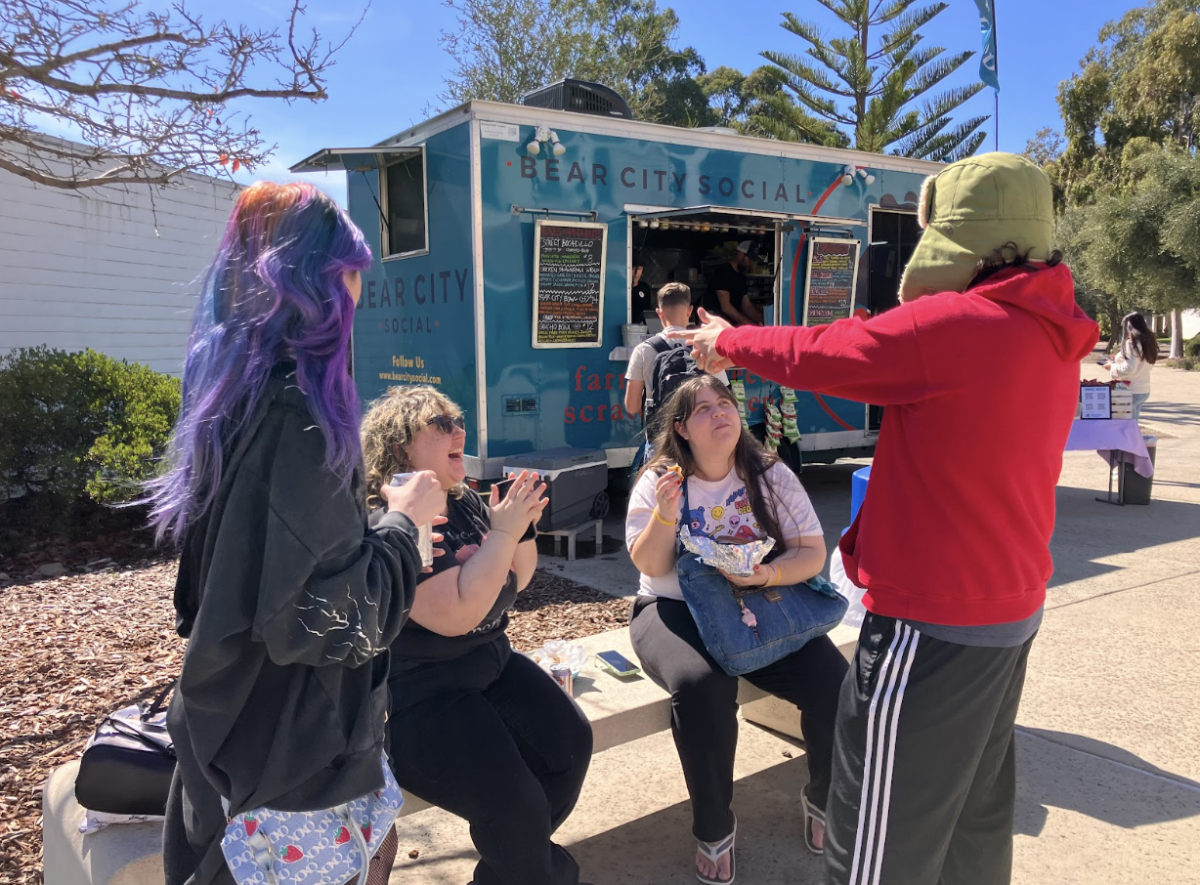 Students laugh and share stories as they wait for their very first orders from Bear City Social’s food truck on March 4.
