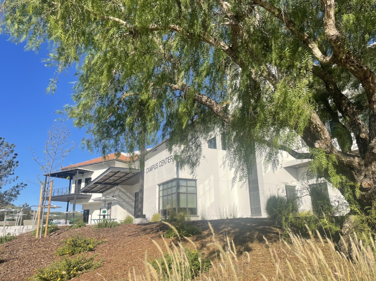 The back side of the Cuesta College SLO Campus Center on April 3, 2026. The back of the building has a landscaped area with tables, and patches of grass for students to spend time between classes or after appointments in the center.