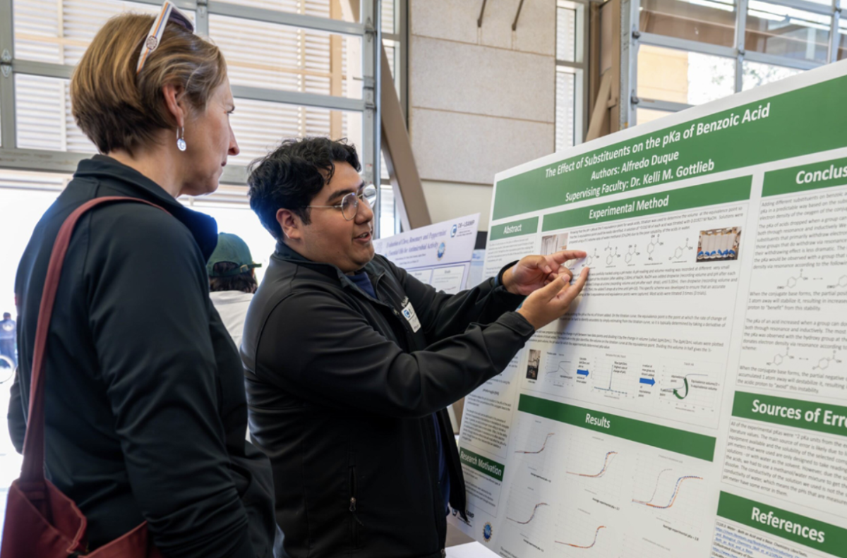 Alfredo Duque (right) shares his research with Biology Instructor Erin Naegle (left) during the 2025 undergraduate research event. Photo courtesy of Alfredo Duque