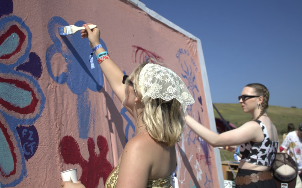 People painting on a canvas during Shabang’s 2025 festival. Photo Credit: The Cuestonian stock photo.
